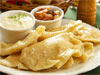 Polish pierogies filled stuffed with cheese and potatoes with cream and bacon